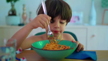 Photo for Child eating spaghetti for lunch, close-up of small boy eats noodles during meal time - Royalty Free Image