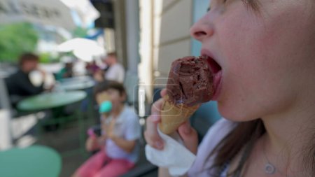 Photo for Woman eating chocolate icecream cone in parlor shop by street, person licking sweet dessert treat, indulgence food - Royalty Free Image