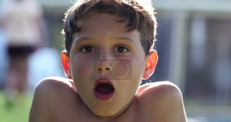 Photo for Boy reacting in shock to news with mouth open. Child looking to camera in disbelief and surprise - Royalty Free Image