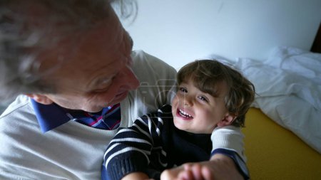 Photo for Grandfather and grandchild bonding together, senior man hugging and playing with grandson. Quality time, family lifestyle scene - Royalty Free Image