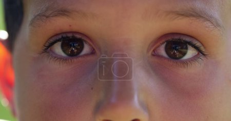 Photo for Child with eyes closed closeup. Kid opening eye in surprise and shock - Royalty Free Image