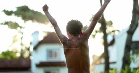 Foto de Self confident child with raised fists celebrating success or victory - Imagen libre de derechos