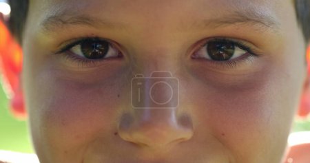 Foto de Kid face close-up closing eyes in meditation. Child boy opening eyes smiling to camera, macro closeup - Imagen libre de derechos