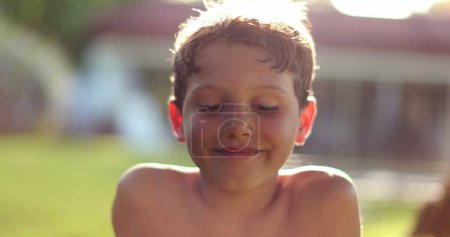 Photo for Handsome young boy staring to camera outside in nature. Portrait of child smiling feeling happy and joy - Royalty Free Image