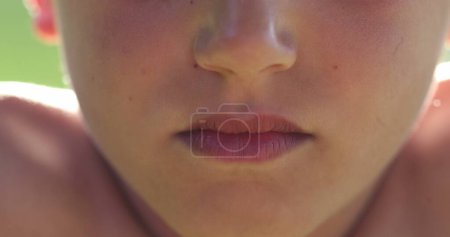 Foto de Upset child boy changing emotion becoming serious. Macro close-up kid lips - Imagen libre de derechos