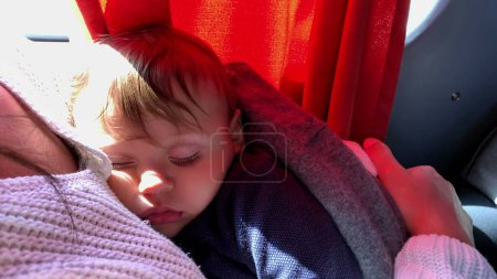 Photo for Baby sleeping inside bus. toddler infant traveling asleep on road - Royalty Free Image