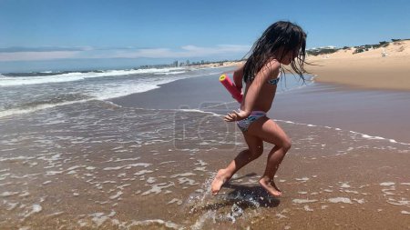 Photo for Happy little girl child running at beach - Royalty Free Image
