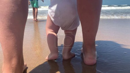Photo for Infant feet and toes walking at sea shore beach - Royalty Free Image