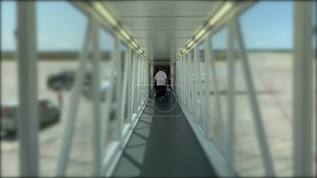 Photo for Passenger perspective boarding plane corridor. POV person walking towards airplane - Royalty Free Image