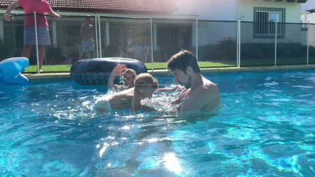 Photo for Father and baby bonding together at the swimming pool. Dad holding infant son at the pool - Royalty Free Image