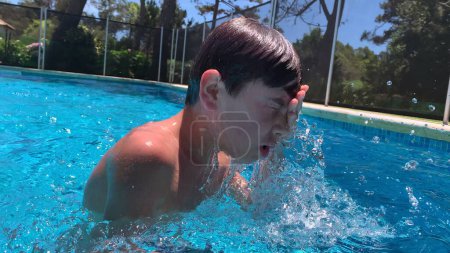 Photo for Young boy child swimming at the pool during summer day. Child swimmer - Royalty Free Image