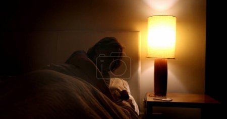 Photo for Sleepless Woman getting out of bed in the middle of the night, waking up at dawn - Royalty Free Image