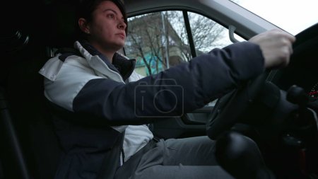 Photo for Woman drives a stick shift truck. Interior of vehicle with female driver stops car on red light - Royalty Free Image