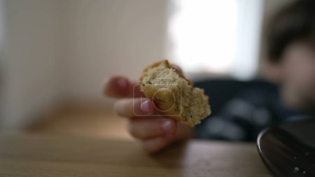 Photo for Close-up of child hand holding piece of bread, kid feeding carb food, wheat ingredient - Royalty Free Image