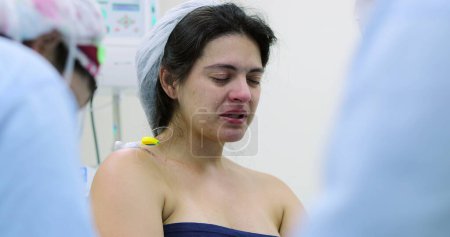 Photo for Candid pregnant woman at hospital feeling pain and suffering - Royalty Free Image