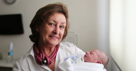 Photo for Grand-mother holding newborn infant baby in arms - Royalty Free Image
