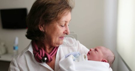 Photo for Newborn baby infant being held by grandmother, real life and authentic - Royalty Free Image