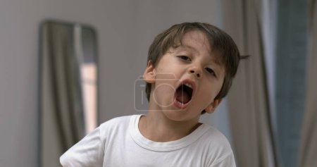 Photo for Angry child yelling and screaming at camera in super slow-motion. Upset male caucasian kid in tantrum mode - Royalty Free Image