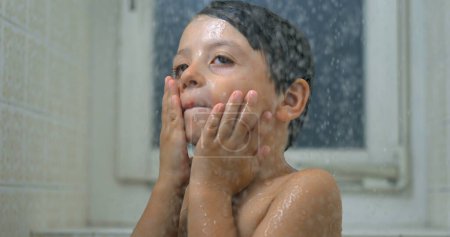 Photo for Child's Close-Up Face During Bath, Super Slow-Motion Water Droplets Flowing in Shower - Royalty Free Image