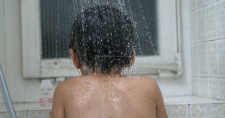 Photo for Back of child with water flower in super ultra slow-motion 800 fps. bathing kid underneath shower head - Royalty Free Image