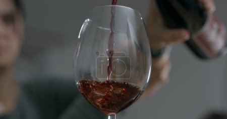 Photo for Serving wine into glass . Pouring alcoholic beverage celebration captured with camera - Royalty Free Image