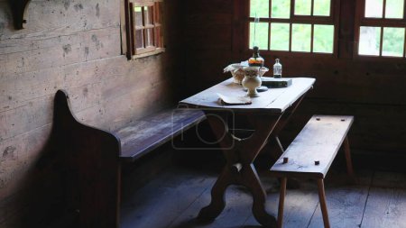 Photo for Wooden furniture in Chalet interior. detail close-up of rural farmhouse, table and chairs. Simple rustic living, handmade - Royalty Free Image