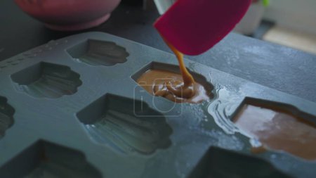 Photo for Making Traditional French Madeleines, Pouring Cake Dough into Shaped Mold - Royalty Free Image