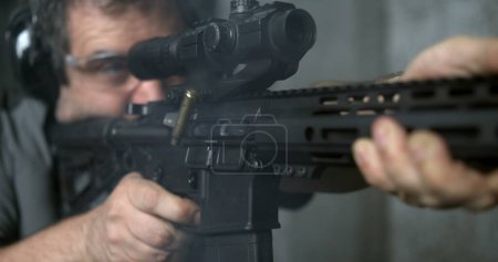 Photo for Firing an Assault rifle in super slow-motion 800 fps. Person shooting with AR-15 detail close-up of gun - Royalty Free Image