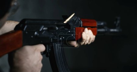 Photo for AK-47 Rifle Firing Captured in Ultra Slow-Motion 800fps, Shooter Aiming and Utilizing Speed-Ramp Technique - Royalty Free Image