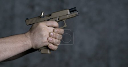 Photo for Shooting with a Sig Sauer P320 9mm close-up pistol in super slow-motion 800 fps - Royalty Free Image
