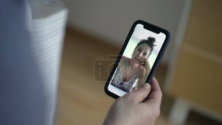 Photo for Video communication, close-up hand holding smartphone speaking with female friend on cellphone device. Video conference, long-distance talk - Royalty Free Image