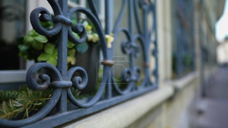 Photo for European Sidewalk Framed by Elegant Window Security metal gate demarcating property protection - Royalty Free Image
