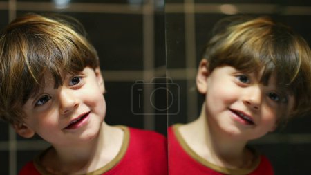 Photo for Smallb oy mirror reflection on bathroom mirror, playful kid looking at his own duplicate - Royalty Free Image