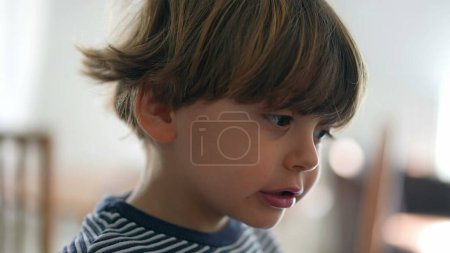 Photo for Child chewing food with open wide mouth, close-up face of little boy eating chewy food, mastication cocnept in deep concentration - Royalty Free Image