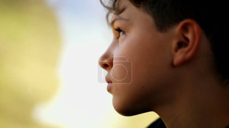 Photo for Introspective child traveling staring at scenery from train window, young boy during journey contemplation - Royalty Free Image