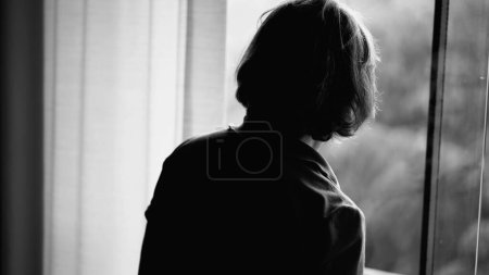 Photo for Elderly Woman Reflecting by Window on Rainy Day in monochrome, black and white scene of Retired Lady Lost in Thought Watching the Rain - Royalty Free Image