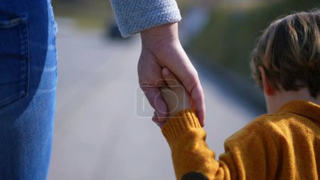 Photo for Mother,child,united,hands,journey,outside,simple,meaningful,act,showcases,timeless,bond,familial,love,walk,forward,path,connection,unity,togetherness,parent,grip,stroll,outdoors,nature,moment,care,affection,guidance,support. - Royalty Free Image