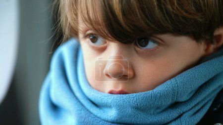 Photo for Close-up of a contemplative young caucasian boy, ensconced in a scarf, reflecting a depth of introspection, encapsulating a profound meditative state - Royalty Free Image