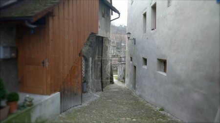 Photo for Empty Narrow European ancient street in Switzerland. Traditional cobblestone and buildings - Royalty Free Image