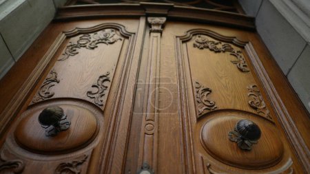 Photo for Antique wooden door with adornment and craftsmanship. Ancient tradtional doorway with beautiful ornamentation - Royalty Free Image