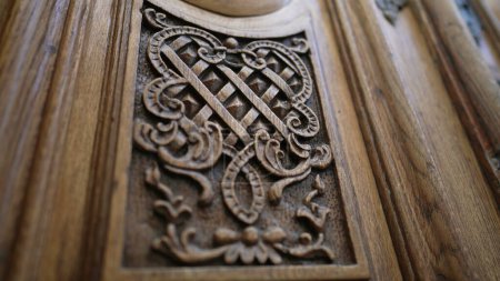 Photo for Beautiful elegant adornment ornamentation engraved on wooden ancient door, traditional antique building architecture - Royalty Free Image