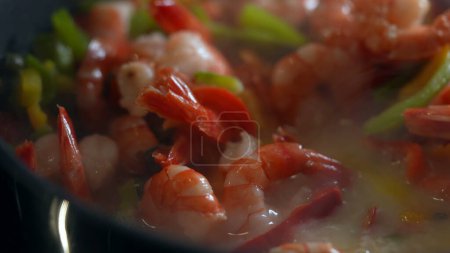 Photo for Cooking shrimps and vegetables inside pan, stirring food and preparing meal macro close-up - Royalty Free Image