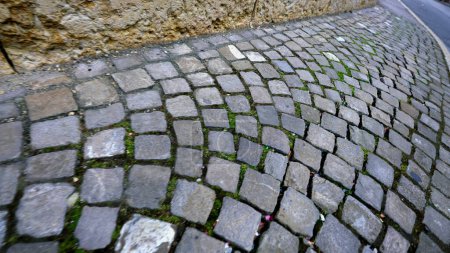 Photo for Antique cobblestone street, detail close-up of sidewalk made of ancient rocks in traditional walkway path in motion - Royalty Free Image