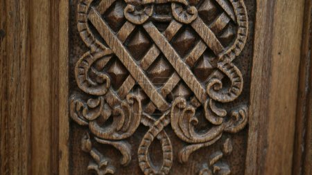 Photo for Rich Historical Elegance - Intricate Engravings on Antique Wooden Door in Traditional Building, Beautiful Adornments on Ancient Door of Age-old European Edifice - Royalty Free Image