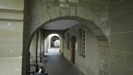 Photo for European traditional architecture pathway corridor underneath buildings with arch made in stone - Royalty Free Image