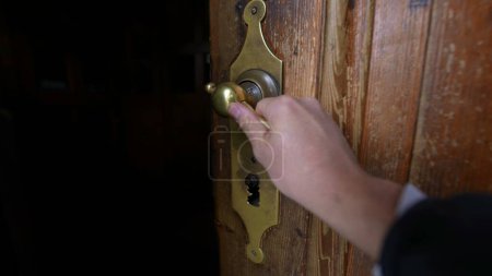 Photo for POV of person hand reaching to door knob entrance, opening gateway to temple. Point of view of individual entering ancient place - Royalty Free Image