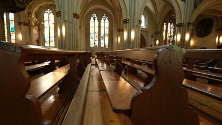 Photo for Ancient Architecture and Benches, Details of Catholic Worship Space? Spiritual Design with Traditional Wooden Seats - Royalty Free Image