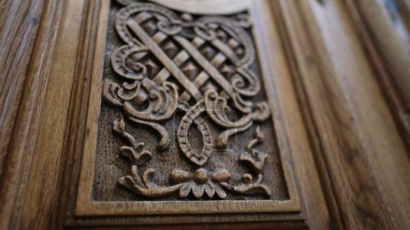 Photo for Beautiful elegant adornment ornamentation engraved on wooden ancient door, traditional antique building architecture - Royalty Free Image