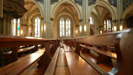 Photo for Inside Catholic Cathedral, shot of wooden benches and beautiful ancient architecture - Royalty Free Image