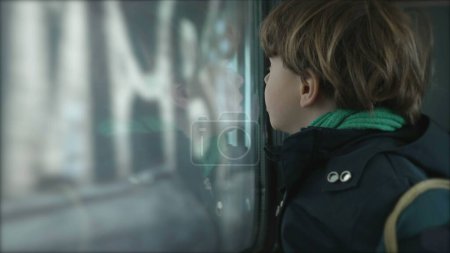 Photo for Little Boy by Train Window Observing as it Enters Tunnel, Child Passenger on High-Speed Journey - Royalty Free Image